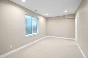 Unfurnished room featuring light colored carpet