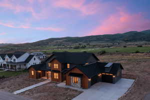 View of front of house with a mountain view and a garage