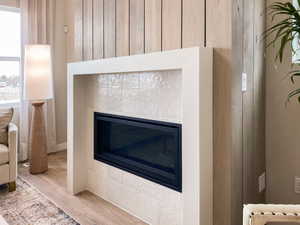 Details featuring hardwood / wood-style flooring and a tile fireplace