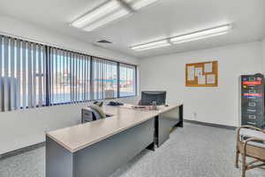 Office area featuring light carpet