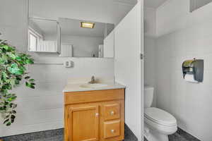 Bathroom featuring vanity and toilet