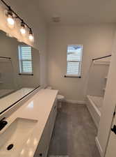 Bathroom with tile patterned flooring, vanity, and toilet