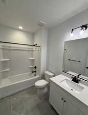 Full bathroom featuring tile patterned flooring, vanity, toilet, and tub / shower combination