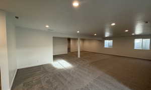 Basement with dark colored carpet