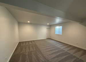 Basement with dark colored carpet