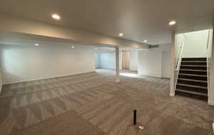 Basement featuring carpet flooring and a textured ceiling