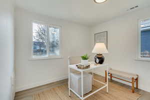 Office area with hardwood / wood-style floors