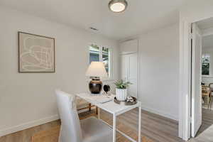 Office with light wood-type flooring