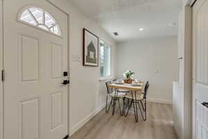 Dining space with light hardwood / wood-style flooring