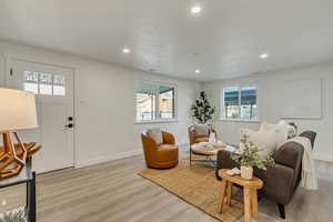 Living room with a healthy amount of sunlight and light wood-type flooring