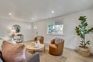 Living room featuring light hardwood / wood-style floors and crown molding