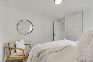 Bedroom with hardwood / wood-style flooring and ornamental molding