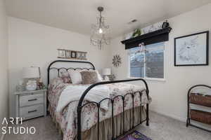 Bedroom featuring carpet floors and a chandelier