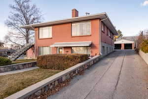 View of home's exterior featuring an outdoor structure and a garage