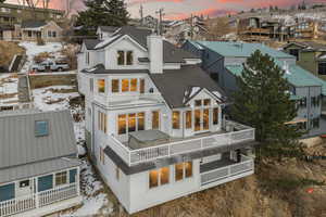 Snow covered property with a balcony