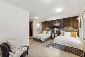 Carpeted bedroom with wooden walls