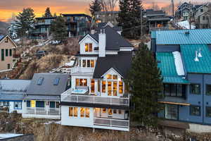 Back house at dusk with a balcony