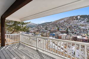 Snow covered deck with a mountain view