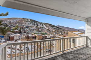 Snow covered back of property featuring a mountain view