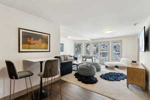 Living room with dark wood-type flooring