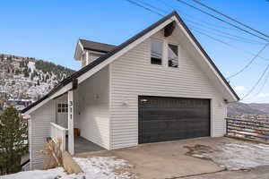 View of snow covered exterior featuring a mountain view