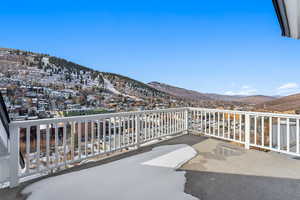 Snow covered back of property with a mountain view