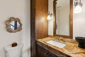 Bathroom featuring vanity and toilet