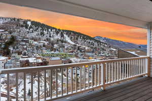 Snow covered deck with a mountain view