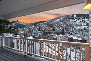 Snow covered deck with a mountain view