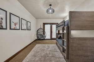 Bedroom with french doors and dark carpet