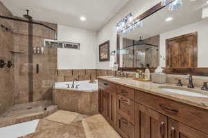 Bathroom with vanity and shower with separate bathtub