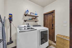 Washroom featuring washing machine and dryer