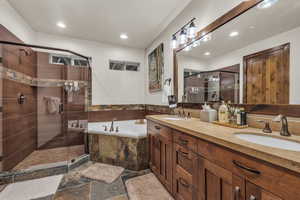 Bathroom featuring vanity and independent shower and bath