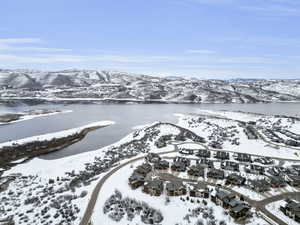 Snowy aerial view with a water and mountain view