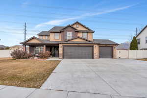 Craftsman inspired home featuring a front yard and a garage