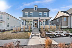 View of front of property featuring a front lawn and a porch