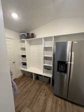 Mudroom featuring LVP floors, lofted ceiling, and a textured ceiling