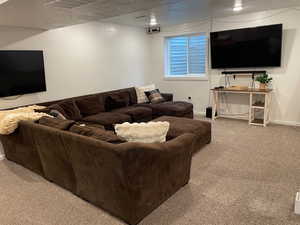 Carpeted living room with a textured ceiling