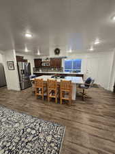 Dining area with dark wood-type flooring and a textured ceiling