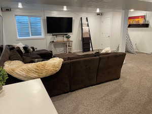 Carpeted living room with a textured ceiling