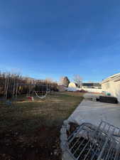 View of yard featuring a playground and a patio area