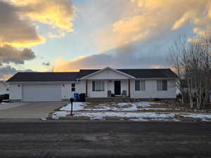 View of front facade featuring a garage and covered porch