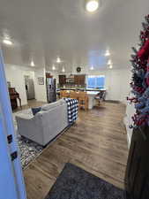 Living room with dark wood-type flooring and a textured ceiling