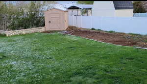 View of yard featuring a storage unit