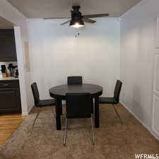 Dining space featuring ceiling fan, light hardwood / wood-style floors, and crown molding