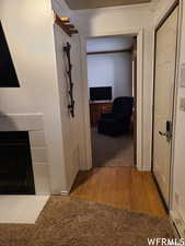 Corridor featuring crown molding and light hardwood / wood-style flooring