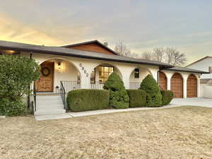 View of front of home with covered porch and a garage