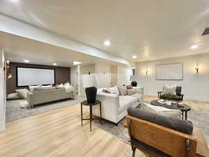 Living room with light wood-type flooring and a textured ceiling