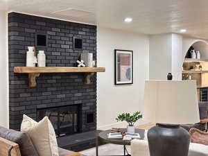 Living room featuring a fireplace and a textured ceiling