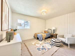 Carpeted bedroom featuring a textured ceiling